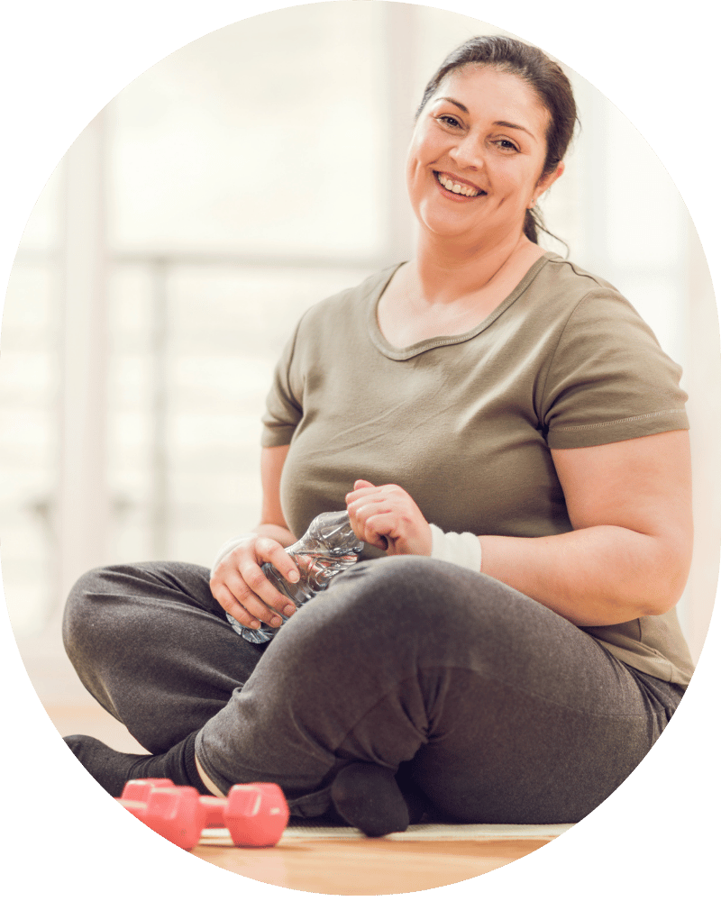 A lady resting from a exercise and taking a drink